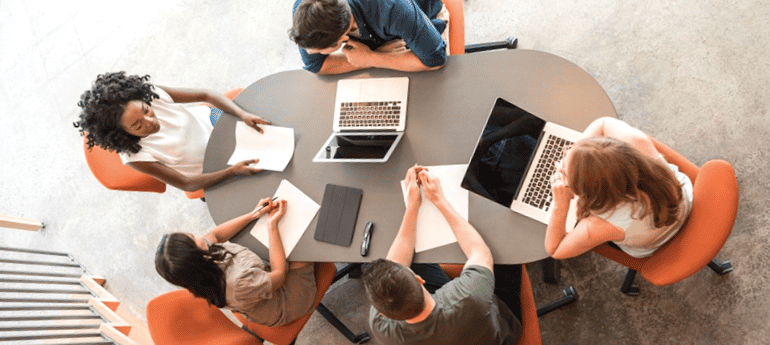 commercial real estate colleagues around a desk 